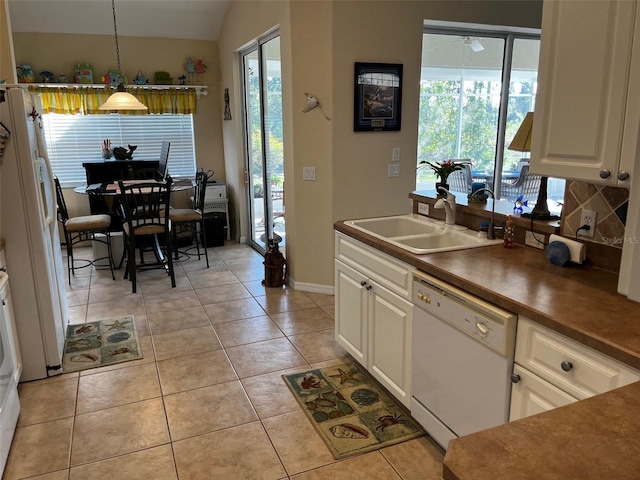 kitchen featuring sink, decorative light fixtures, light tile patterned floors, white appliances, and white cabinets