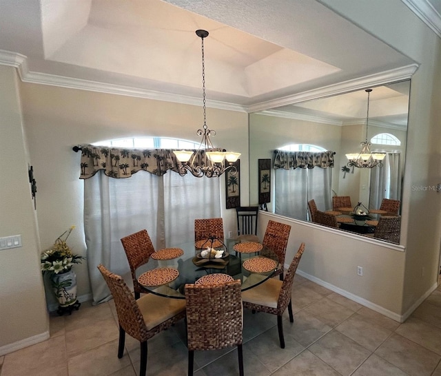 dining area featuring a raised ceiling, crown molding, tile patterned flooring, and a chandelier