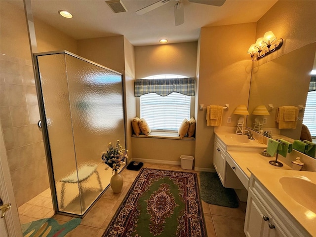 bathroom with ceiling fan, vanity, tile patterned flooring, and a shower with door