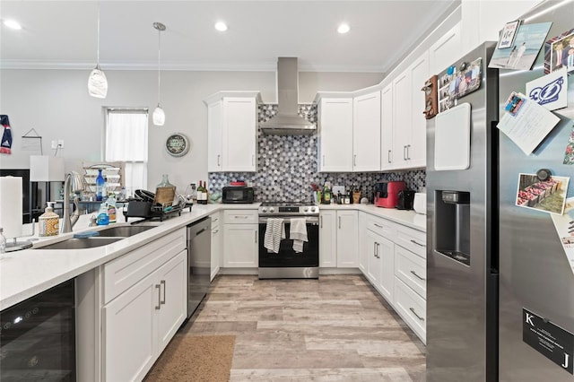 kitchen with beverage cooler, stainless steel appliances, a sink, decorative backsplash, and wall chimney exhaust hood