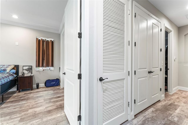 hall with crown molding, recessed lighting, light wood-style flooring, and baseboards