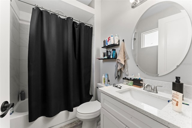 bathroom featuring shower / bath combo, vanity, and toilet