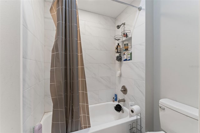 bathroom with shower / tub combo with curtain and toilet