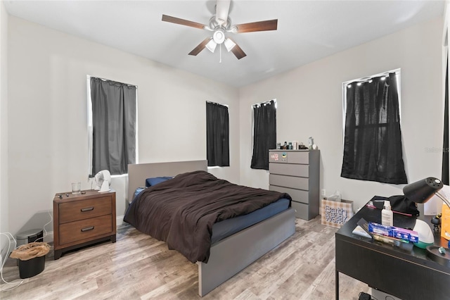 bedroom with light wood finished floors and a ceiling fan