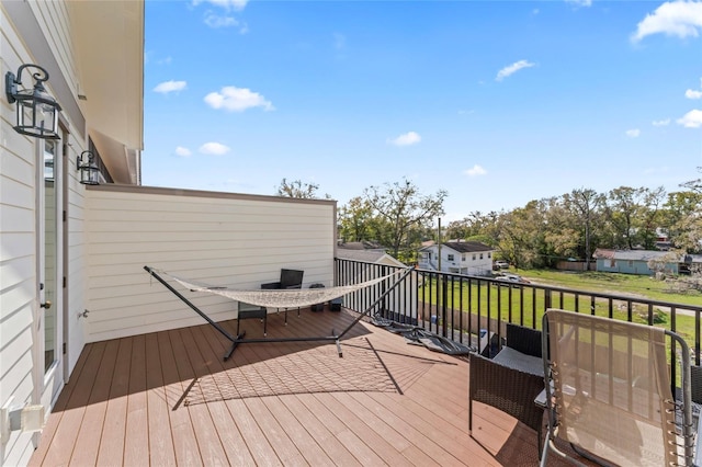 deck with a residential view and a yard