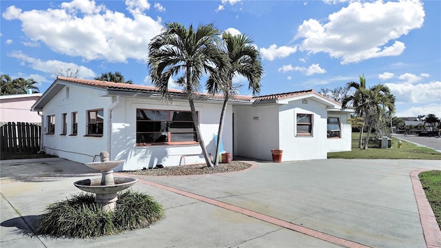 mediterranean / spanish-style home with central air condition unit