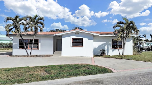 mediterranean / spanish-style house featuring a front yard