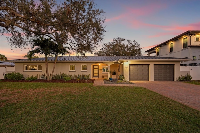 view of front of home featuring a yard and a garage