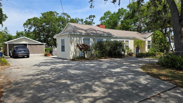 1372 Palmetto St, Clearwater, FL 33755 - view of front of home with concrete driveway, a carport, and a chimney