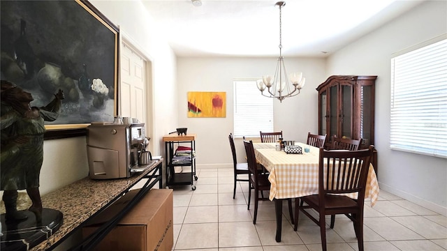 1372 Palmetto St, Clearwater, FL 33755 - dining room featuring baseboards, light tile patterned floors, and a chandelier