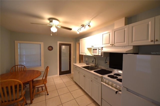1372 Palmetto St, Clearwater, FL 33755 - kitchen featuring white appliances, light tile patterned floors, under cabinet range hood, a sink, and a ceiling fan