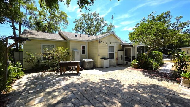 1372 Palmetto St, Clearwater, FL 33755 - rear view of house with a sunroom and a patio