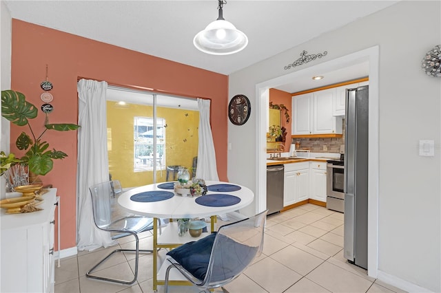 tiled dining room featuring sink