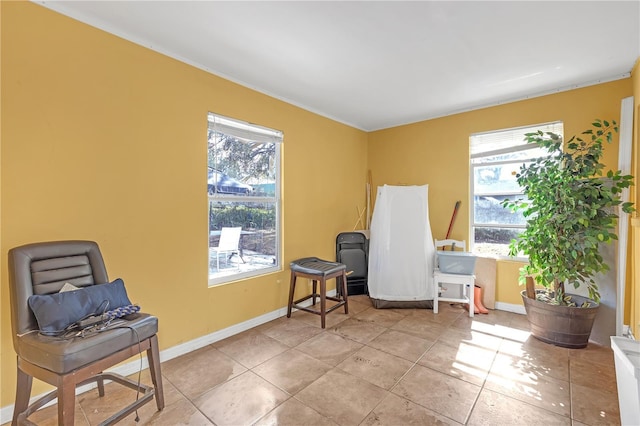 sitting room with light tile patterned flooring and a healthy amount of sunlight