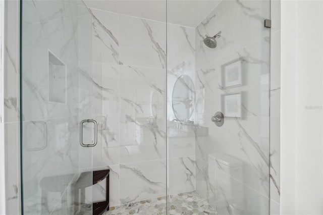 full bathroom with a marble finish shower