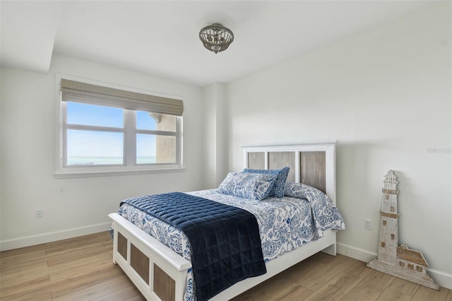 bedroom featuring wood finished floors and baseboards