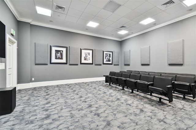 carpeted home theater with visible vents, crown molding, and baseboards