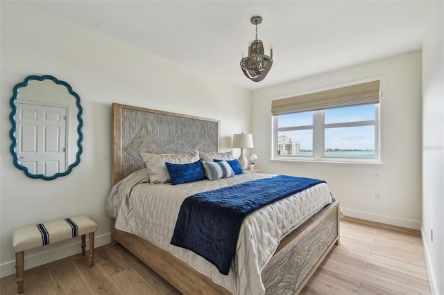 bedroom with light wood-style floors and baseboards