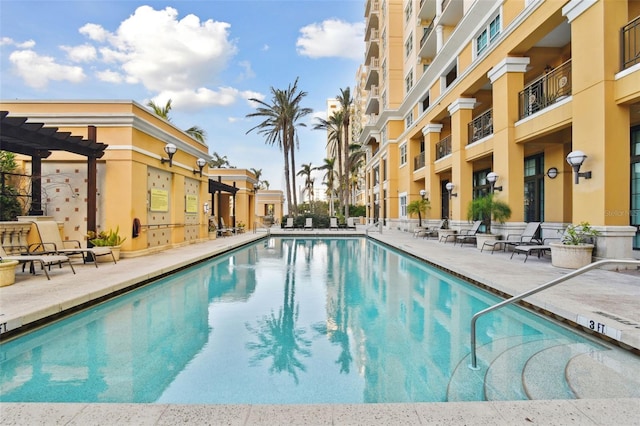 community pool with a patio and a pergola