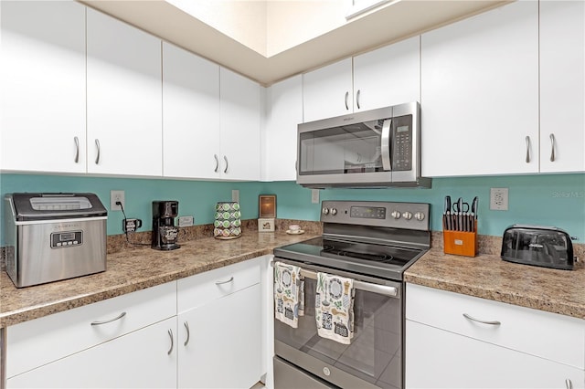 kitchen with white cabinets and appliances with stainless steel finishes