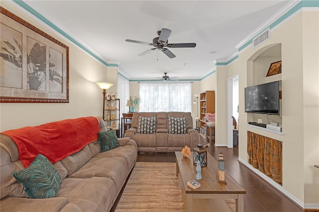 living room with hardwood / wood-style floors, crown molding, and ceiling fan