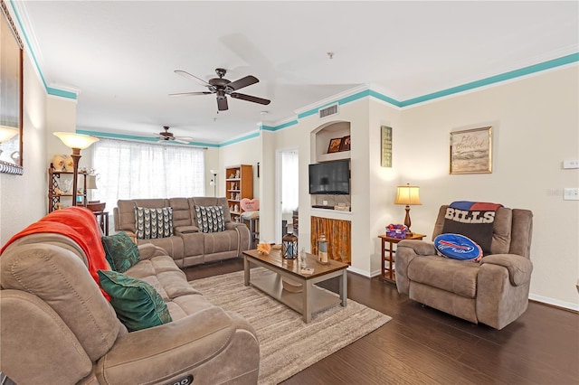 living room with dark hardwood / wood-style flooring, crown molding, and ceiling fan