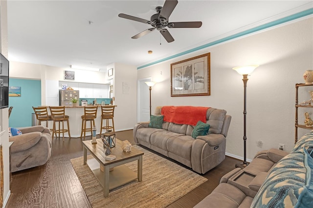 living room with ceiling fan and dark hardwood / wood-style floors