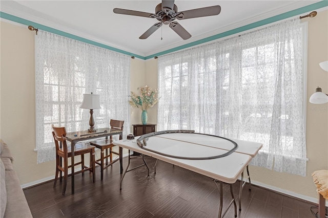 dining room with dark hardwood / wood-style flooring, crown molding, and ceiling fan