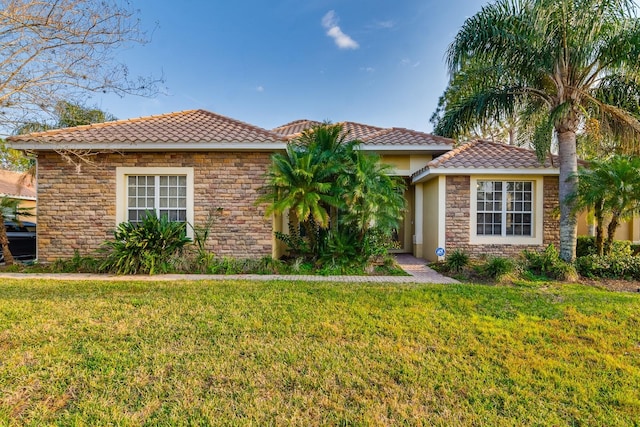 10534 Bermuda Isle Dr, Tampa, FL 33647 - mediterranean / spanish-style home with a front yard
