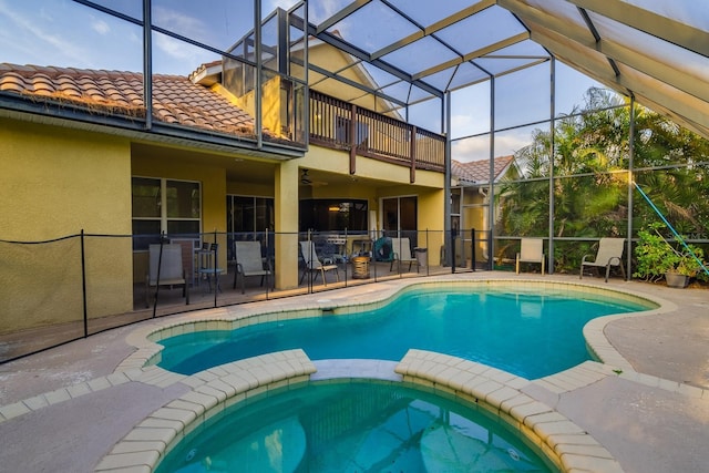 10534 Bermuda Isle Dr, Tampa, FL 33647 - view of swimming pool featuring an in ground hot tub, glass enclosure, and a patio