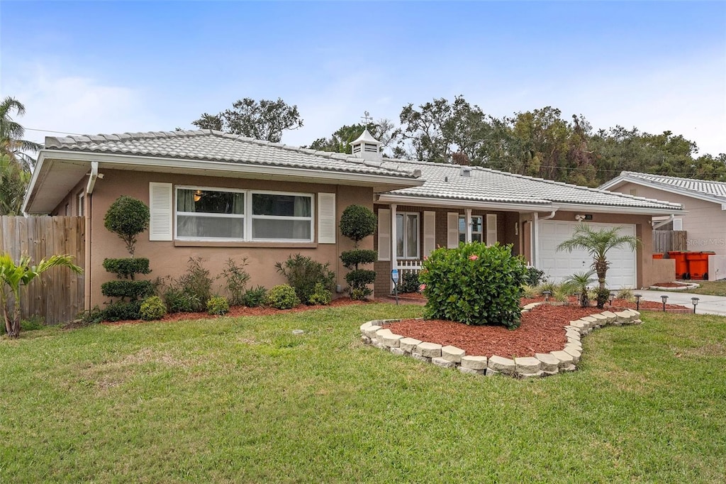 ranch-style house with a garage and a front lawn