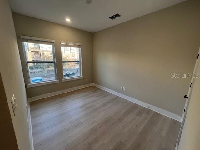 spare room featuring light hardwood / wood-style floors