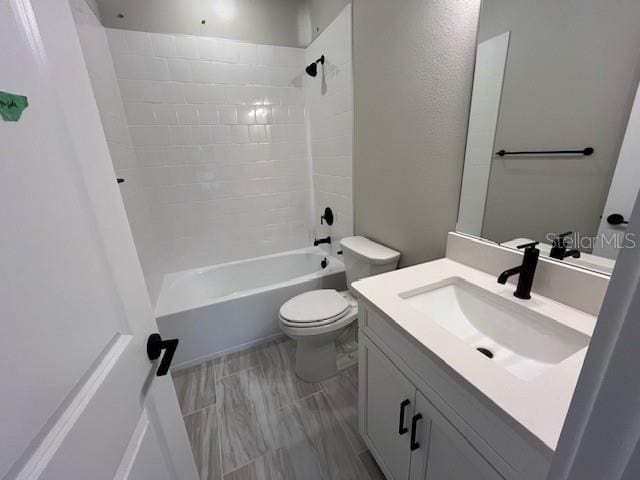 full bathroom with vanity, toilet, and tiled shower / bath