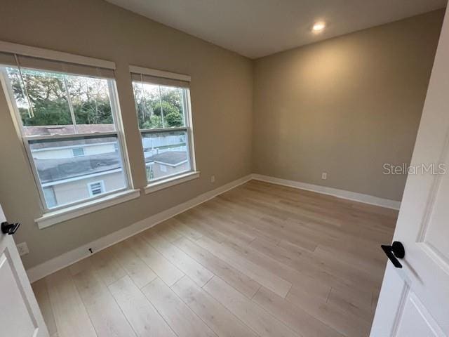 unfurnished room featuring light hardwood / wood-style floors