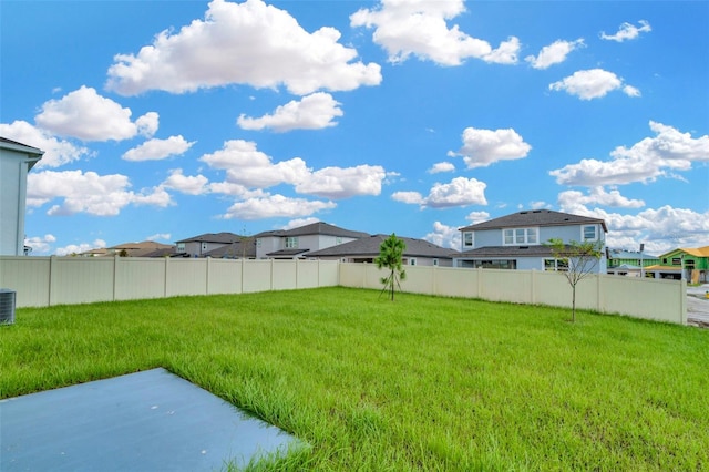 view of yard with cooling unit and a patio