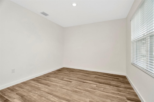 unfurnished room featuring hardwood / wood-style floors and a wealth of natural light