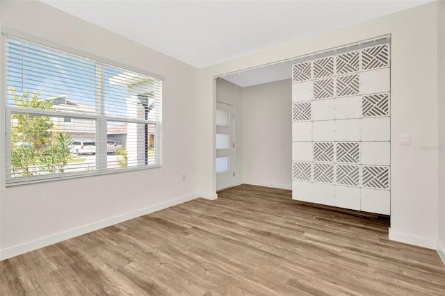 unfurnished room with wood-type flooring