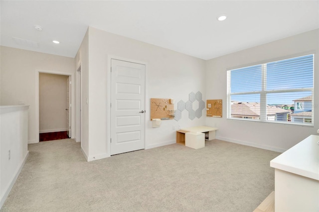 bedroom featuring light carpet