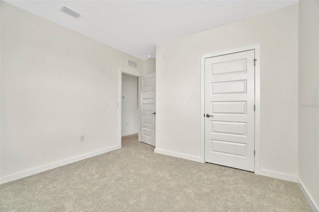 unfurnished bedroom with light carpet