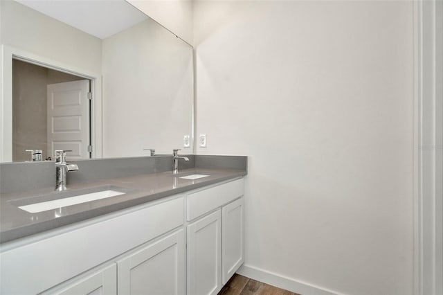 bathroom with vanity and wood-type flooring