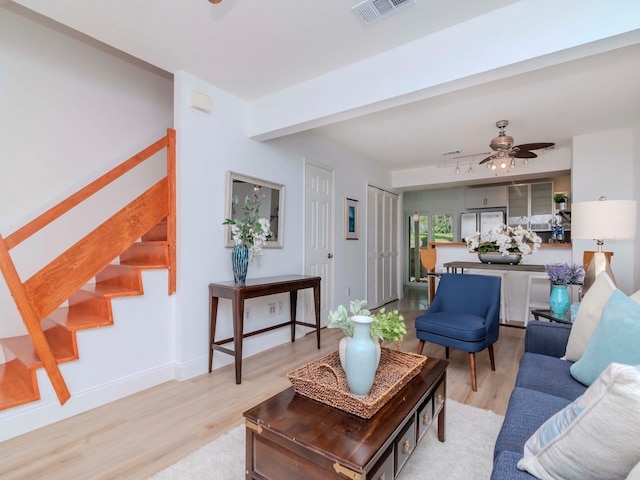 living room with ceiling fan and light wood-type flooring