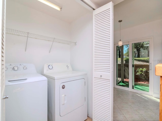 clothes washing area featuring washing machine and clothes dryer and light tile patterned floors