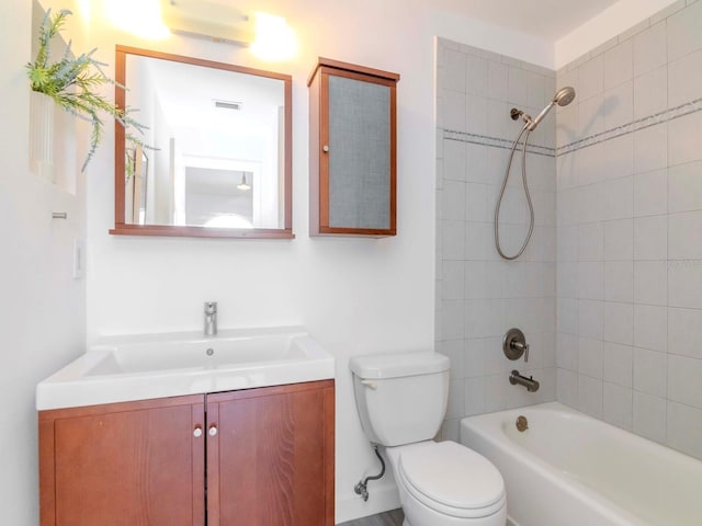 full bathroom with vanity, tiled shower / bath combo, an AC wall unit, and toilet