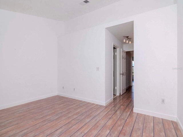 unfurnished room featuring light hardwood / wood-style floors