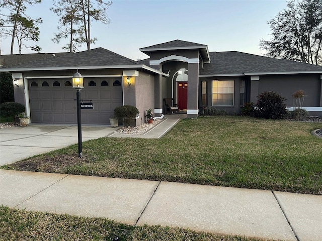 view of front of property featuring a garage and a front yard