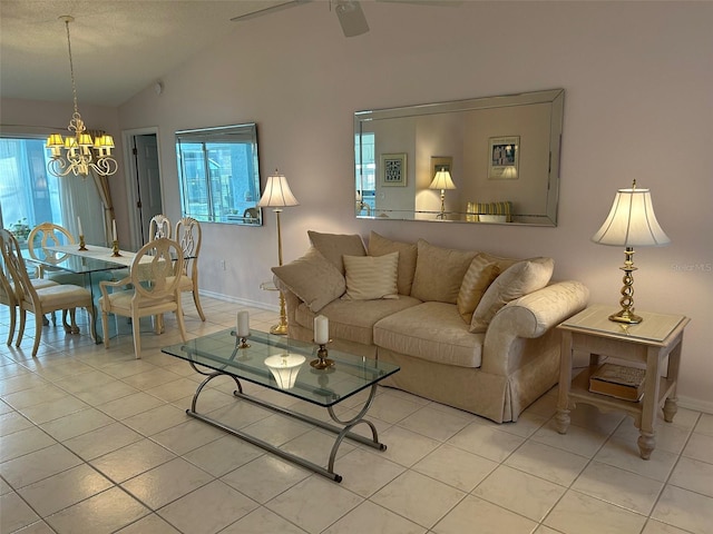 tiled living room with ceiling fan with notable chandelier and vaulted ceiling