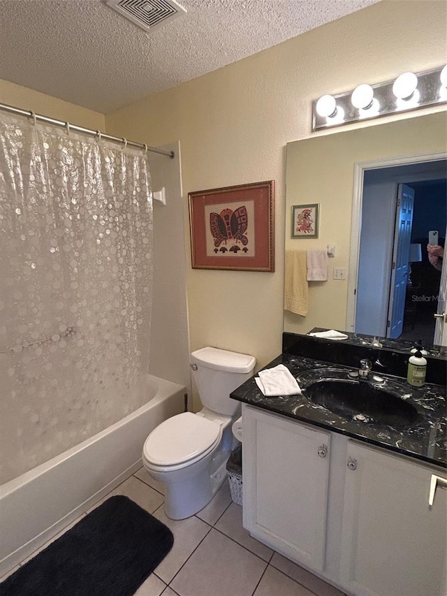 full bathroom featuring shower / tub combo with curtain, tile patterned flooring, vanity, a textured ceiling, and toilet