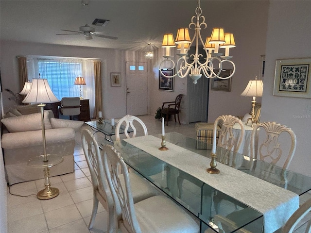 tiled dining room featuring ceiling fan with notable chandelier