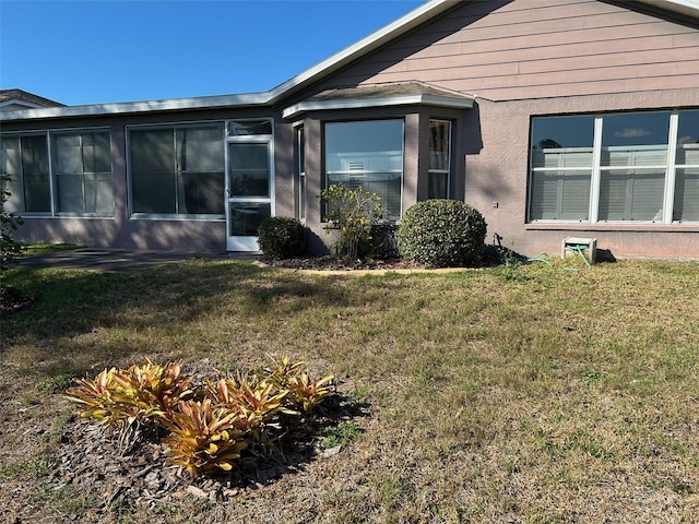 view of home's exterior with a yard