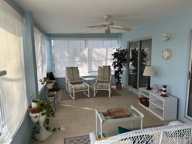 sunroom featuring ceiling fan